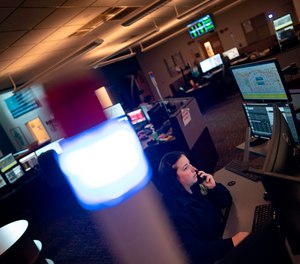 A dispatcher with Anne Arundel County Fire Department answers a 911 emergency call from their department dispatch center in Glen Burnie, Maryland.