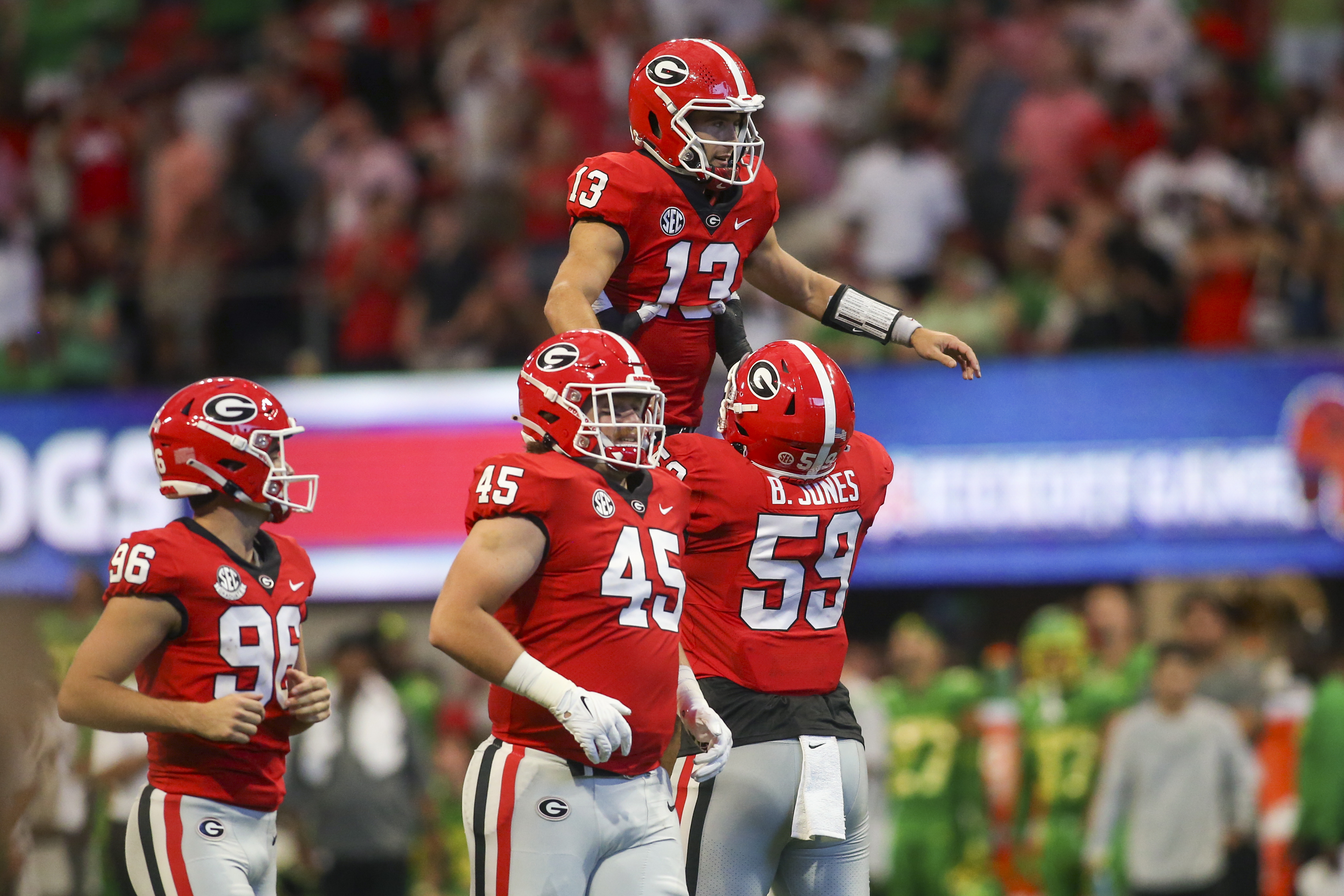 Sep 3, 2022; Atlanta, Georgia; Georgia Bulldogs quarterback Stetson Bennett (13) celebrates with offensive lineman Broderick Jones (59) after a touchdown pass against the Oregon Ducks in the second quarter at Mercedes-Benz Stadium. Brett Davis-USA TODAY Sports